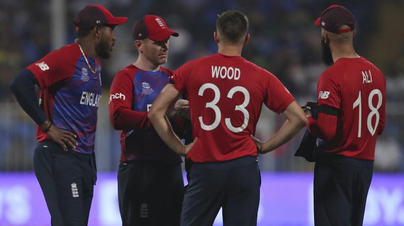 Englands captain Eoin Morgan interacts with bowlers Chris Jordan (left) Mark Wood and Moeen Ali, right, during the Cricket Twenty20 World Cup match between England and South Africa in Sharjah on Saturday. (AP Photo)