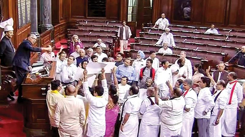 Opposition members, including Tamil Nadu MPs belonging to AIADMK and DMK, protest in the well of the Rajya Sabha in New Delhi on Tuesday. — PTI Opposition members, including Tamil Nadu MPs belonging to AIADMK and DMK, protest in the well of the Rajya Sabha in New Delhi on Tuesday. — PTI