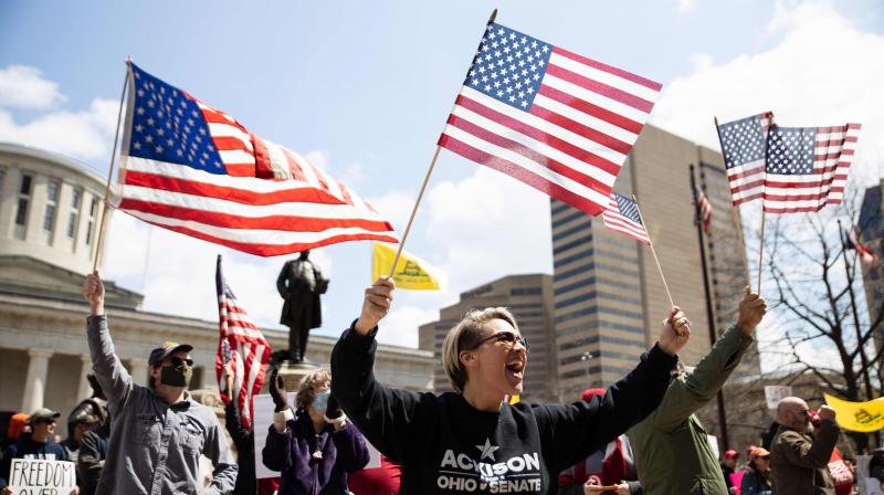 Protesters wave flags outside of the Ohio State House in Columbus, Ohio. AFP Photo
