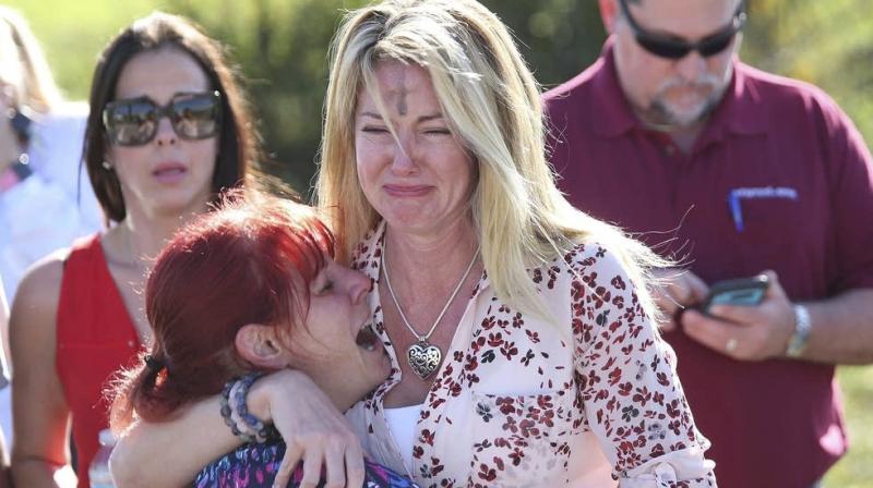 Parents wait for news after a reports of a shooting at Marjory Stoneman Douglas High School in Parkland. (Photo: AP) Parents wait for news after a reports of a shooting at Marjory Stoneman Douglas High School in Parkland. (Photo: AP)