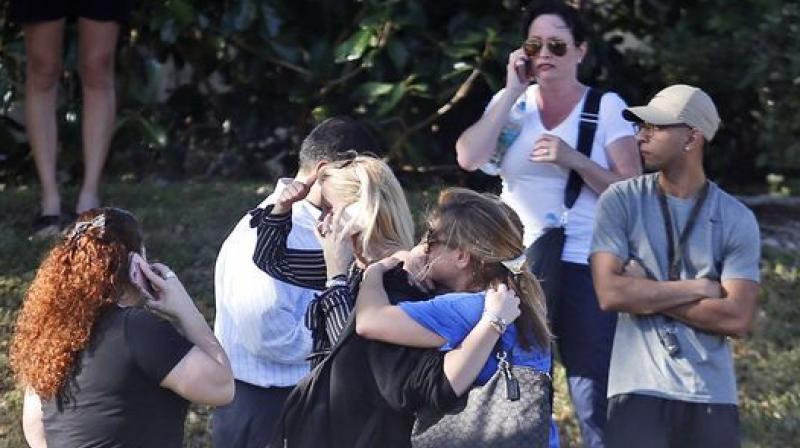 Parents wait for news after a reports of a shooting at Marjory Stoneman Douglas High School in Parkland. (Photo: AP) Parents wait for news after a reports of a shooting at Marjory Stoneman Douglas High School in Parkland. (Photo: AP)