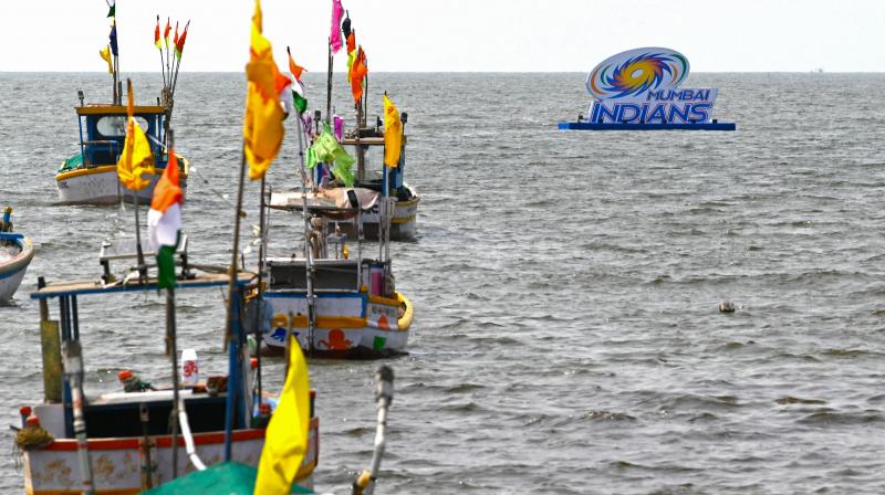 Boats are anchored near a logo of Indian Premier Leagues (IPL) Mumbai Indians team displayed ahead of the Tata IPL 2022 season, in the Arabian Sea off coast in Mumbai on March 25, 2022. (AFP)