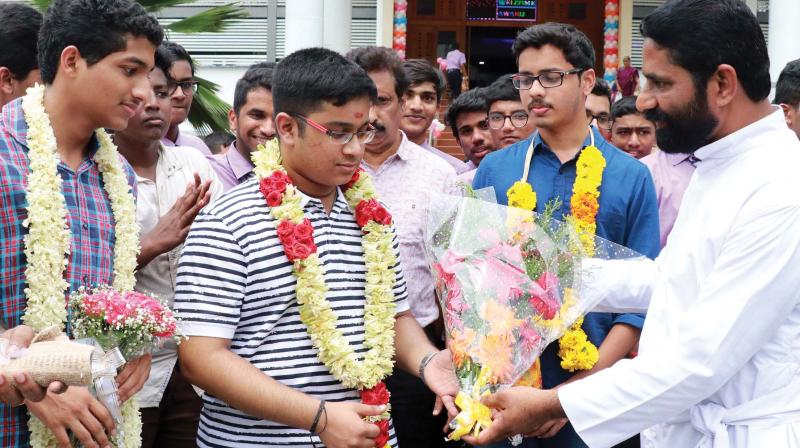 Fr James Mullaseri, principal, KE School, Mannanam, congratulates engineering entrance examination rank holders and the students of the school Goudam Govind (2nd rank), Vishnu Vinod (1st rank) and Mevitt Mathew (5th rank) on Monday. (Photo: Rajeev Prasad) Fr James Mullaseri, principal, KE School, Mannanam, congratulates engineering entrance examination rank holders and the students of the school Goudam Govind (2nd rank), Vishnu Vinod (1st rank) and Mevitt Mathew (5th rank) on Monday. (Photo: Rajeev Prasad)