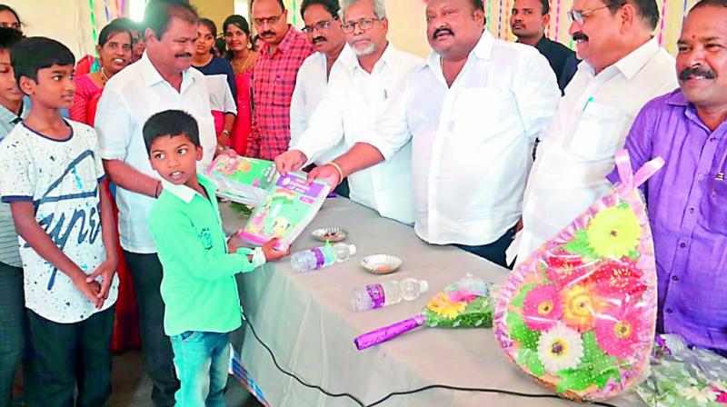 MLA Gangula Kamalakar distributes books to students on Monday. —DC MLA Gangula Kamalakar distributes books to students on Monday. —DC