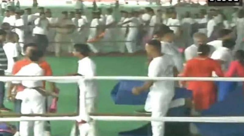 A pandemonium broke out when people started looting yoga mats at the venue where Union Home Minister Amit Shah and Chief Minister Manohar Lal Khattar participated in a yoga programme in Rohtak district of Haryana on Friday. (Photo: Screengrab/ ANI Twitter) A pandemonium broke out when people started looting yoga mats at the venue where Union Home Minister Amit Shah and Chief Minister Manohar Lal Khattar participated in a yoga programme in Rohtak district of Haryana on Friday. (Photo: Screengrab/ ANI Twitter)