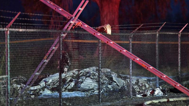 A skydiving plane crashed and burst into flames just after takeoff from a small seaside airfield on the island of Oahu, killing 11 people, officials said on Saturday. (Photo: AP) A skydiving plane crashed and burst into flames just after takeoff from a small seaside airfield on the island of Oahu, killing 11 people, officials said on Saturday. (Photo: AP)