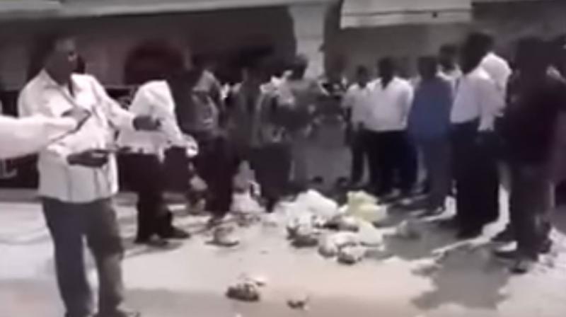 A video of GHMC food inspectors throwing stale food on the main road after they inspected Swagath Grand hotel, is going viral on social media. (Image courtesy: Youtube) A video of GHMC food inspectors throwing stale food on the main road after they inspected Swagath Grand hotel, is going viral on social media. (Image courtesy: Youtube)