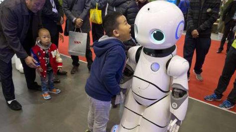 In this Friday, Oct. 21, 2016 photo, a Chinese boy shouts into the Canbot, a companion robot, displayed during the World Robot Conference in Beijing, China. China is showcasing its burgeoning robot industry as it seeks to promote use of more advanced technologies in Chinese factories and create high-end products that redefine the meaning of "Made in China." The Canbot can dance and respond to voice commands, while others can play badminton, sand cell phone cases and sort computer chips. (AP Photo/Ng Han Guan) Read more at: http://phys.org/news/2016-10-robots-center-china-strategy-leapfrog.html#jCp In this Friday, Oct. 21, 2016 photo, a Chinese boy shouts into the Canbot, a companion robot, displayed during the World Robot Conference in Beijing, China. China is showcasing its burgeoning robot industry as it seeks to promote use of more advanced technologies in Chinese factories and create high-end products that redefine the meaning of "Made in China." The Canbot can dance and respond to voice commands, while others can play badminton, sand cell phone cases and sort computer chips. (AP Photo/Ng Han Guan) Read more at: http://phys.org/news/2016-10-robots-center-china-strategy-leapfrog.html#jCp