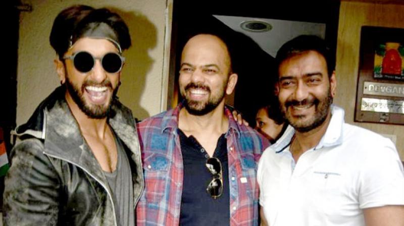 Ranveer Singh, Rohit Shetty and Ajay Devgn pose for the camera. Ranveer Singh, Rohit Shetty and Ajay Devgn pose for the camera.