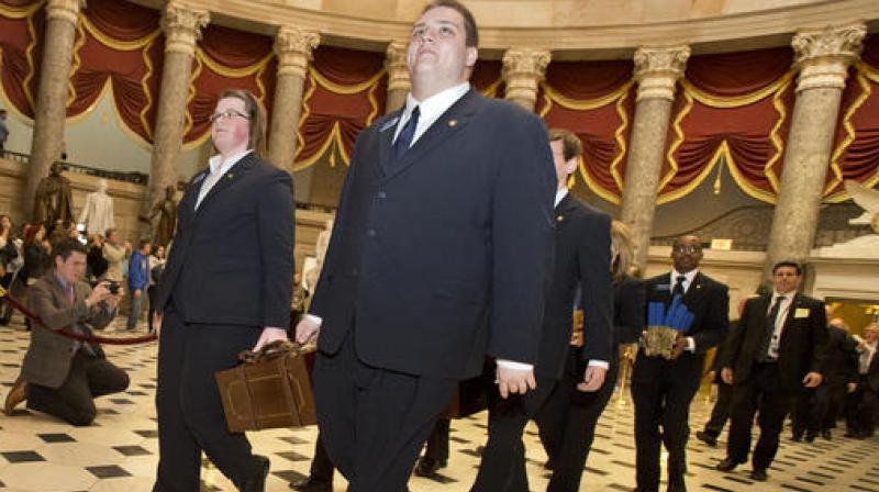 A Senate procession carrying two boxes holding Electoral College votes through Statuary Hall to the House Chamber on Capitol Hill on Capitol Hill in Washington. (Photo: AP) A Senate procession carrying two boxes holding Electoral College votes through Statuary Hall to the House Chamber on Capitol Hill on Capitol Hill in Washington. (Photo: AP)