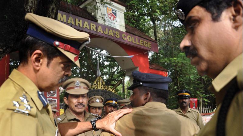 City police commissioner M.P. Dinesh examines a policeman who came under attack during a clash between two groups of students at Maharaja’s College in Kochi on Friday. (Photo: SUNOJ NINAN MATHEW) City police commissioner M.P. Dinesh examines a policeman who came under attack during a clash between two groups of students at Maharaja’s College in Kochi on Friday. (Photo: SUNOJ NINAN MATHEW)