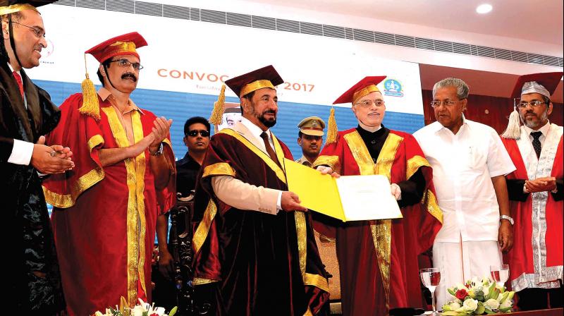 Kerala Governor and Chancellor of Calicut University P. Sathasivam confers the D Litt by Calicut University on the UAE Supreme Council member and Sharjah ruler Sheikh Sultan Bin Muhammed Al Qasimi at a function in Raj Bhavan on Tuesday. Calicut University registrar Dr T.A. Abdul Majeed, pro-chancellor and education minister C. Raveendranath, Chief minister Pinarayi Vijayan and vice-chancellor Dr K. Mohammed Basheer, pro vice-chancellor Dr P. Mohan look on. (Photo: DC) Kerala Governor and Chancellor of Calicut University P. Sathasivam confers the D Litt by Calicut University on the UAE Supreme Council member and Sharjah ruler Sheikh Sultan Bin Muhammed Al Qasimi at a function in Raj Bhavan on Tuesday. Calicut University registrar Dr T.A. Abdul Majeed, pro-chancellor and education minister C. Raveendranath, Chief minister Pinarayi Vijayan and vice-chancellor Dr K. Mohammed Basheer, pro vice-chancellor Dr P. Mohan look on. (Photo: DC)