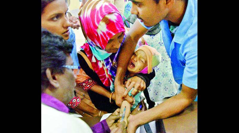 A lab assistant collects blood samples from a child for testing at Gandhi Hospital in Hyderabad on Saturday in view of fast spreading viral fever in the city. (Photo: Gandhi) A lab assistant collects blood samples from a child for testing at Gandhi Hospital in Hyderabad on Saturday in view of fast spreading viral fever in the city. (Photo: Gandhi)