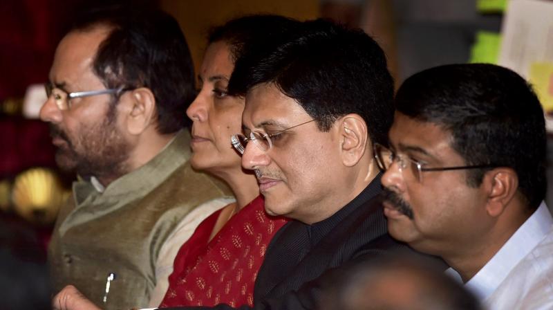 Cabinet Minister Piyush Goyal checks time in his wrist watch as he waits with cabinet colleagues Nirmala Sitharaman, Mukhtar Abbas Naqvi and Dharmendra Pradhan for the swearing in ceremony at Rashtrapati Bhavan in New Delhi on Sunday. (Photo: PTI) Cabinet Minister Piyush Goyal checks time in his wrist watch as he waits with cabinet colleagues Nirmala Sitharaman, Mukhtar Abbas Naqvi and Dharmendra Pradhan for the swearing in ceremony at Rashtrapati Bhavan in New Delhi on Sunday. (Photo: PTI)
