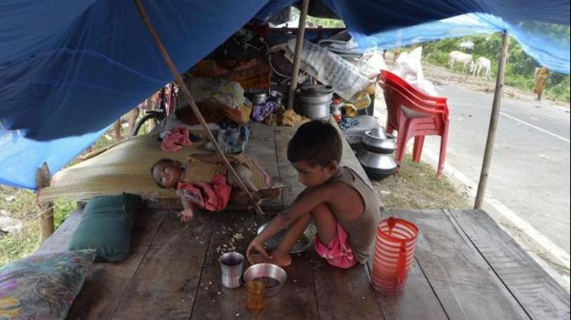 Children rest in a makeshift tent set up along a road in flood-affected Purnia district of Bihar state on August 18, 2017. (Photo: AFP) Children rest in a makeshift tent set up along a road in flood-affected Purnia district of Bihar state on August 18, 2017. (Photo: AFP)