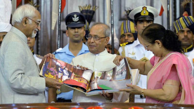 President Pranab Mukherjee is presented a coffee-table book by Vice President Hamid Ansari and Lok Sabha Speaker Sumitra Mahajan during his farewell ceremony in the Central Hall of Parliament in New Delhi on Sunday. (Photo: PTI) President Pranab Mukherjee is presented a coffee-table book by Vice President Hamid Ansari and Lok Sabha Speaker Sumitra Mahajan during his farewell ceremony in the Central Hall of Parliament in New Delhi on Sunday. (Photo: PTI)