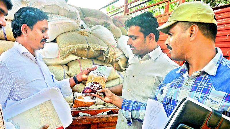 File picture of Civil Supplies officials check seized PDS grains. File picture of Civil Supplies officials check seized PDS grains.
