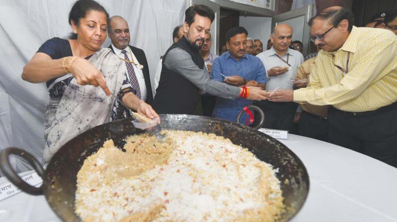Union finance minister Nirmala Sitharaman and MoS Anurag Thakur distribute halwa to officials during the “halwa ceremony” to mark the beginning of the printing of budgetary documents in New Delhi. (Photo: PTI) Union finance minister Nirmala Sitharaman and MoS Anurag Thakur distribute halwa to officials during the “halwa ceremony” to mark the beginning of the printing of budgetary documents in New Delhi. (Photo: PTI)
