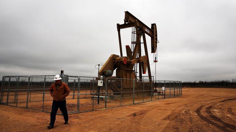 Oil prices creep up on demand recovery, tempered by virus outbreaks. (AFP Photo)