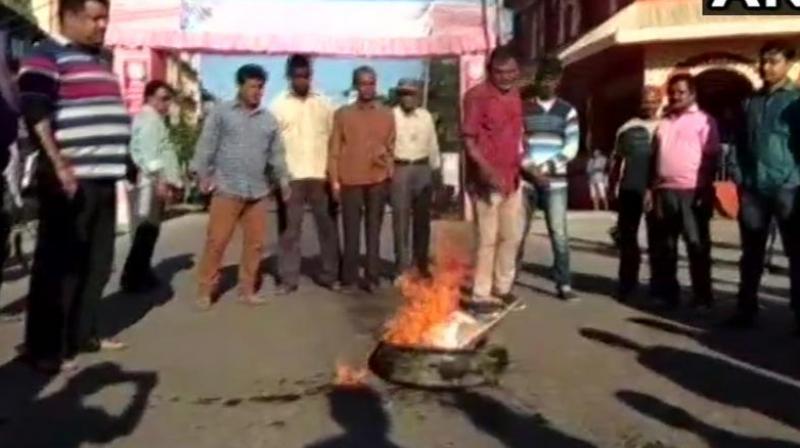 All Assam Bengali Youth Students Federation has called a 12-hour shutdown in Tinsukia in protest against the murder of 5 people killed by ULFA terrorists in Bishnoimukh village. (Photo: Twitter | ANI) All Assam Bengali Youth Students Federation has called a 12-hour shutdown in Tinsukia in protest against the murder of 5 people killed by ULFA terrorists in Bishnoimukh village. (Photo: Twitter | ANI)