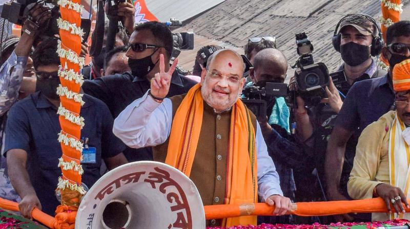 Union Home Minister Amit Shah during a roadshow in support of BJP candidates ahead of the 5th phase of West Bengal Assembly polls at Santipur in Nadia, Sunday, April 11,2021. (PTI)