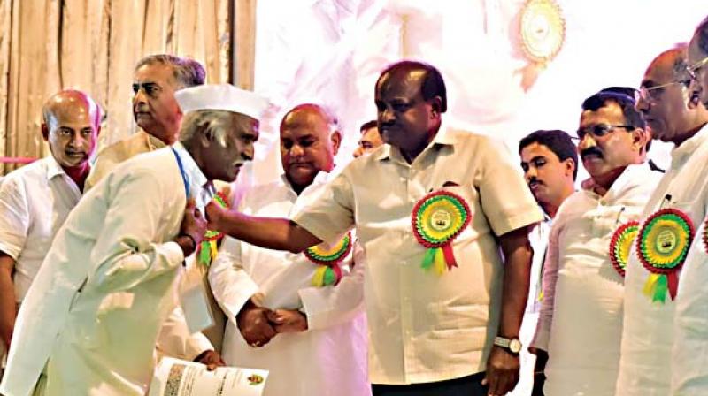 Chief Minister H.D. Kumaraswamy distributes debt-free certificates to farmers in Bagalkote on Friday Chief Minister H.D. Kumaraswamy distributes debt-free certificates to farmers in Bagalkote on Friday