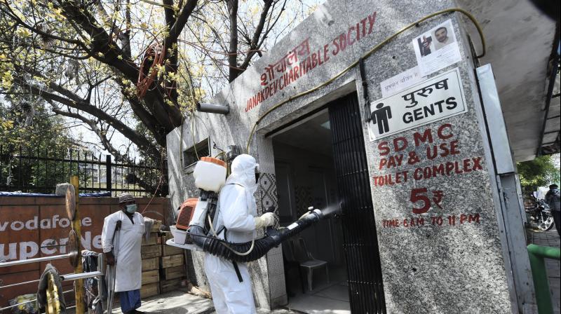 Health workers sanitise an area near Nizammuddin mosque, after people who attended the religious congregation at Tabligh-e-Jamaats Markaz, tested positive for COVID-19, in New Delhi. PTI photo