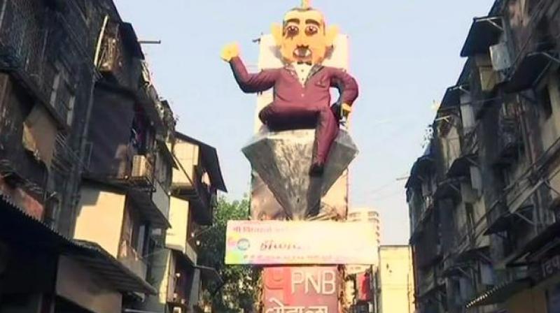 The residents of BDD Chawl in Mumbai's Worli area have created a 58-feet high effigy of Nirav Modi, symbolising the evil character of Holika, to burn it as a part of the festival's tradition. (Photo: ANI | Twitter) The residents of BDD Chawl in Mumbai's Worli area have created a 58-feet high effigy of Nirav Modi, symbolising the evil character of Holika, to burn it as a part of the festival's tradition. (Photo: ANI | Twitter)