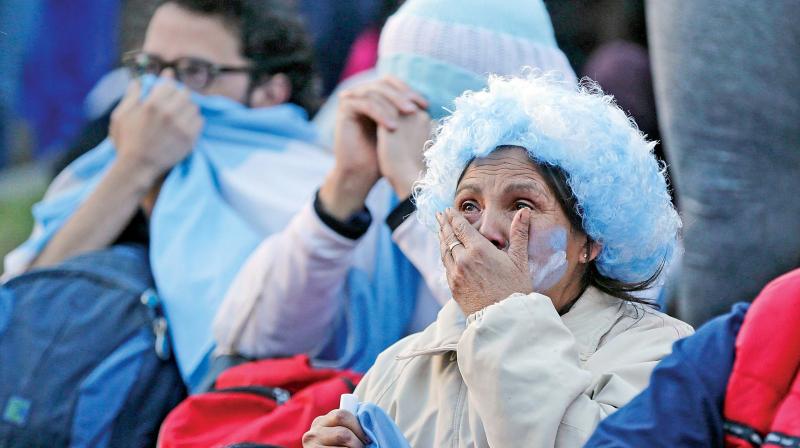 Argentina fans react in disbelief at the end of a televised broadcast of the Croatia vs. Argentina World Cup soccer match, in Buenos Aires, Argentina, on Thursday. (Photo:AP) Argentina fans react in disbelief at the end of a televised broadcast of the Croatia vs. Argentina World Cup soccer match, in Buenos Aires, Argentina, on Thursday. (Photo:AP)
