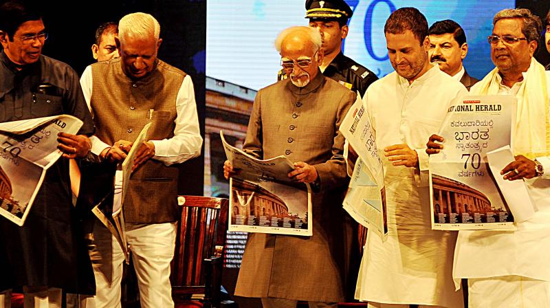 Congress leaders Oscar Fernandes, Rahul Gandhi, Siddaramaiah with Vice-President Hamid Ansari and Governor Vajubhai Vala at the re-launch function. (Photo: DC) Congress leaders Oscar Fernandes, Rahul Gandhi, Siddaramaiah with Vice-President Hamid Ansari and Governor Vajubhai Vala at the re-launch function. (Photo: DC)