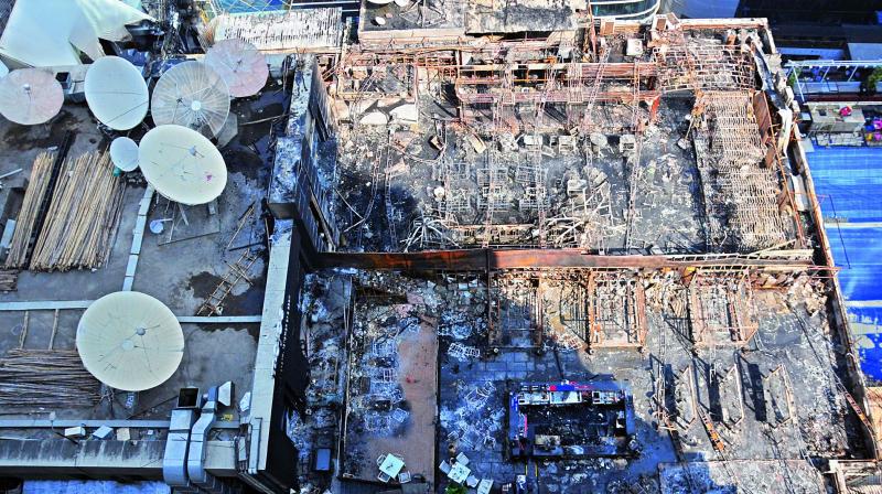 A view of the charred building in which a fire broke out in Mumbai on early Friday. A view of the charred building in which a fire broke out in Mumbai on early Friday.