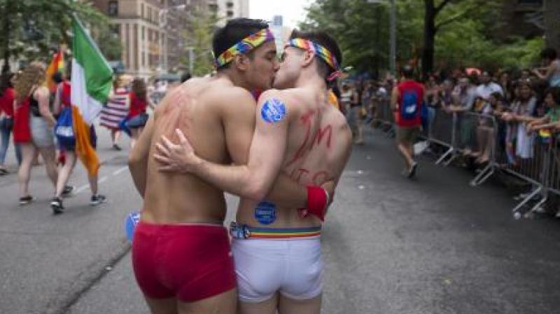A couple kisses as they participate in the Heritage Pride March in New York. (Photo: AP) A couple kisses as they participate in the Heritage Pride March in New York. (Photo: AP)