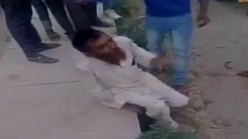 A mob of cow vigilantes associated with the Bajrang Dal and Vishwa Hindu Parishad (VHP) beat up Khan and 4 others badly. (Photo: Videograb) A mob of cow vigilantes associated with the Bajrang Dal and Vishwa Hindu Parishad (VHP) beat up Khan and 4 others badly. (Photo: Videograb)