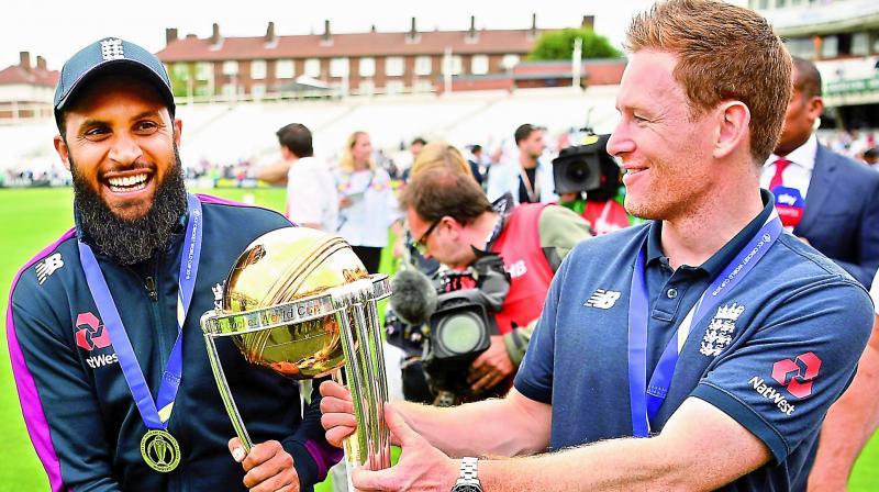 England captain Eoin Morgan (right) and Adil Rashid with the World Cup trophy. (AFP) England captain Eoin Morgan (right) and Adil Rashid with the World Cup trophy. (AFP)