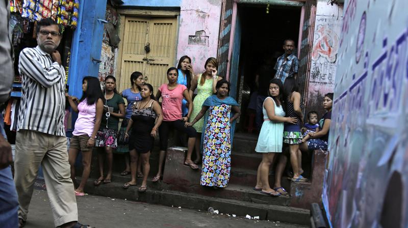 Girls stand outside the Kolkata's biggest red-light zone, Sonagachhi. (Photo: AP) Girls stand outside the Kolkata's biggest red-light zone, Sonagachhi. (Photo: AP)