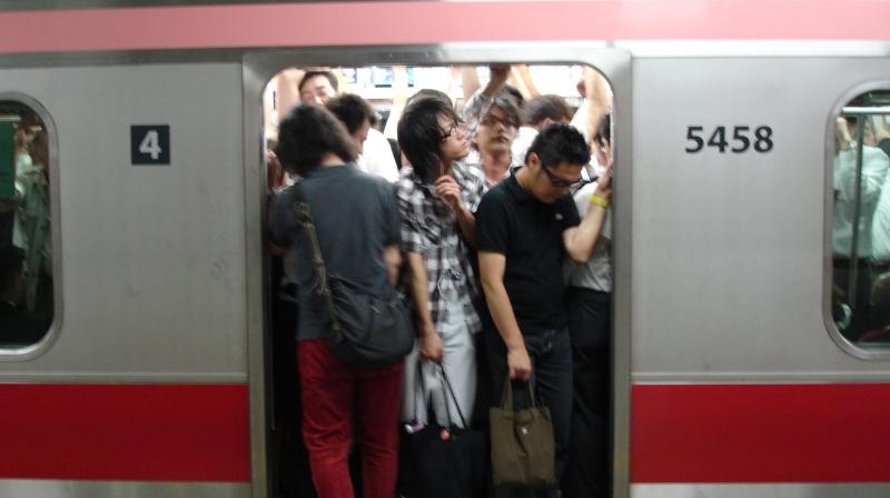 Workers still cram onto commuter trains—albeit in smaller numbers—and Japan’s parliament is hardly setting the tone for working from home, continuing to hold sessions and ministerial press conferences. (Representative Image) Workers still cram onto commuter trains—albeit in smaller numbers—and Japan’s parliament is hardly setting the tone for working from home, continuing to hold sessions and ministerial press conferences. (Representative Image)