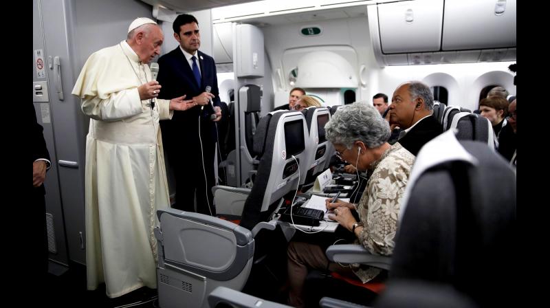 Pope Francis, with Vatican spokesman Alessandro Gisotti, answers reporters' questions aboard the plane after taking off from Panama City. (Photo: AP) Pope Francis, with Vatican spokesman Alessandro Gisotti, answers reporters' questions aboard the plane after taking off from Panama City. (Photo: AP)