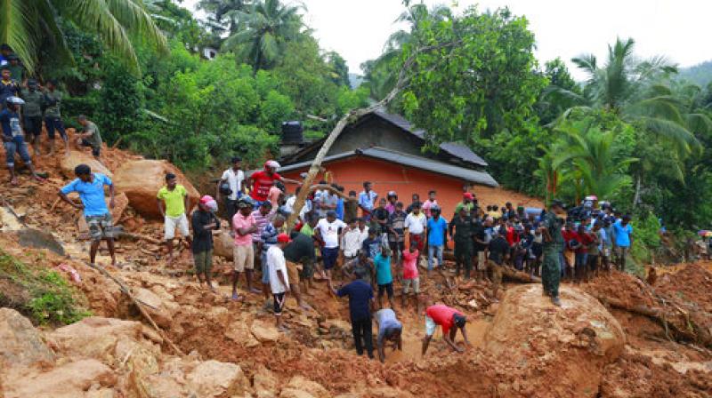 Sri Lankans watch military rescue efforts at the site of a landslide in Bellana village in Kalutara district, Sri Lanka (Photo: AP) Sri Lankans watch military rescue efforts at the site of a landslide in Bellana village in Kalutara district, Sri Lanka (Photo: AP)