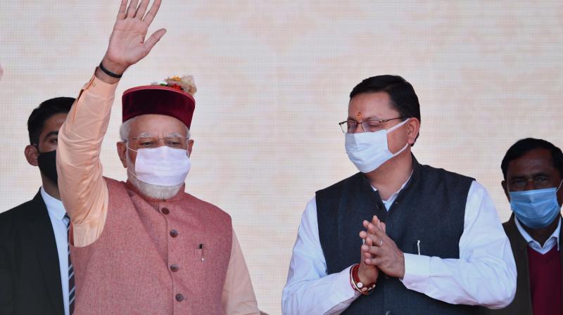 Prime Minister Narendra Modi with Uttarakhand CM Pushkar Singh Dhami during BJP election campaign rally, ahead of state Assembly polls in 2022, in Dehradun, Saturday, Dec. 4, 2021. (PTI File)