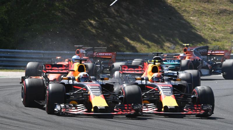 Red Bulls Australian driver Daniel Ricciardo (L) and Red Bulls Dutch driver Max Verstappen collide as they race at the Hungaroring circuit in Budapest in 2017. AFP Photo