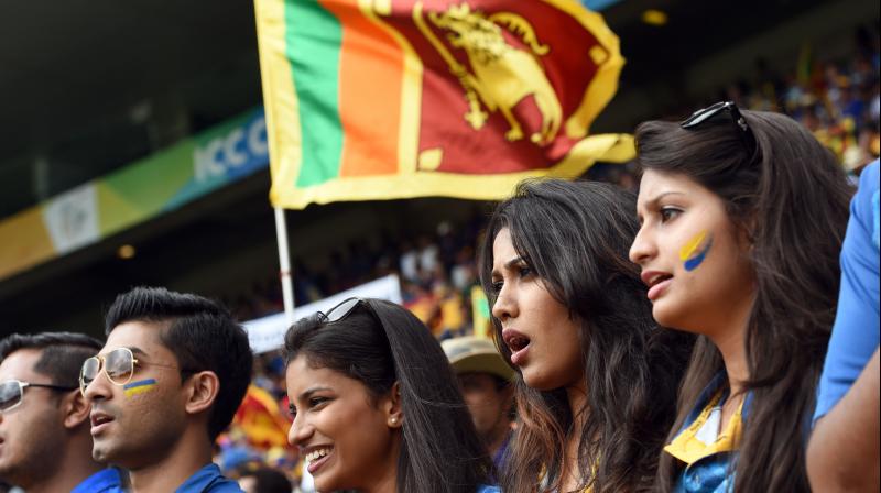 Sri Lanka fans sing the national anthem as they cheer their team against Australia at the World Cup. AFP Photo Sri Lanka fans sing the national anthem as they cheer their team against Australia at the World Cup. AFP Photo