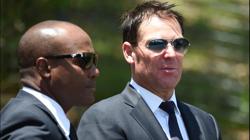 Former Australian bowler Shane Warne (R) and West Indies batsman Brian Lara at Australian batsman Phillip Hughes funeral in Macksville, northern New South Wales. AFP Photo