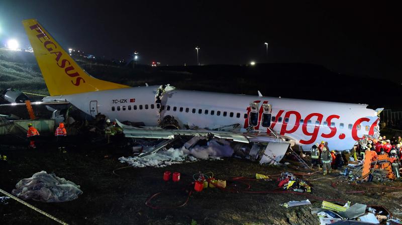 Rescuers work to extract passengers from the crash of a Pegasus Airlines Boeing 737 airplane after it skidded off the runway upon landing at Sabiha Gokcen airport in Istanbul on February 5, 2020. The plane carrying 171 passengers from the Aegean port city of Izmir split into three after landing in rough weather. Officials said no-one lost their lives in the accident, but dozens of people were injured. (AFP)