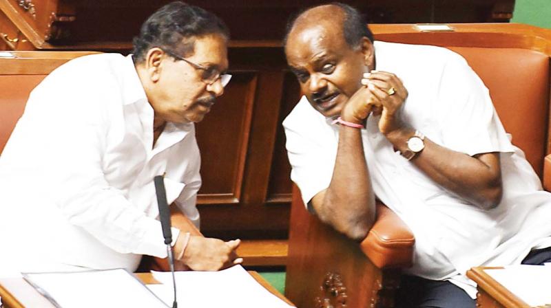 Chief Minister H.D. Kumaraswamy talks to Deputy CM Dr G. Parameshwar during the monsoon session of the state legislature at Vidhana Soudha in Bengaluru on Friday. Chief Minister H.D. Kumaraswamy talks to Deputy CM Dr G. Parameshwar during the monsoon session of the state legislature at Vidhana Soudha in Bengaluru on Friday.
