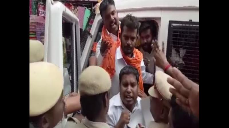 Activists of Maruthu Thiruvar Makkal Kazgham on Sunday staged a protest outside the Meenakshi Amman Temple here over a missing statue in the temple in Madurai in Tamil Nadu. (Photo: ANI) Activists of Maruthu Thiruvar Makkal Kazgham on Sunday staged a protest outside the Meenakshi Amman Temple here over a missing statue in the temple in Madurai in Tamil Nadu. (Photo: ANI)