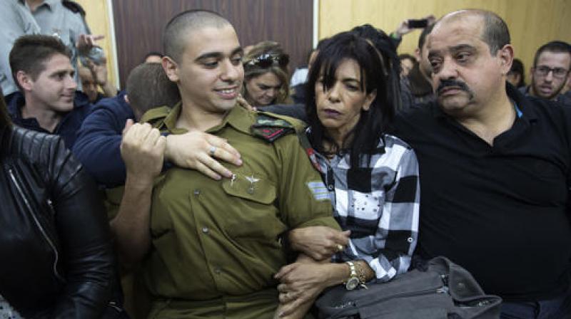 Israeli solider Sgt. Elor Azaria waits with his parents for the verdict inside the military court in Tel Aviv, Israel on Wednesday. (Photo: AP) Israeli solider Sgt. Elor Azaria waits with his parents for the verdict inside the military court in Tel Aviv, Israel on Wednesday. (Photo: AP)