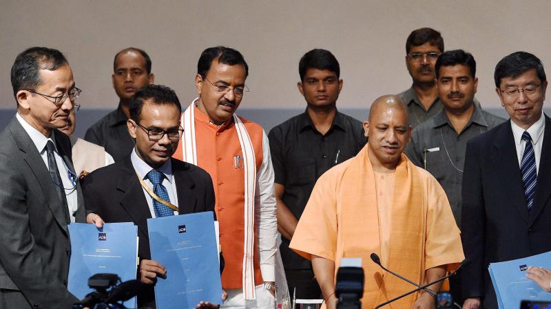 Uttar Pradesh Chief Minister Yogi Aditiyanath with Takehiko Nakao, President Asian Development Bank after signing up of agreement between U P Government and ADB at Lok Bhawan in Lucknow on Tuesday. UP Deputy Chief Minister Keshav Prasad Maurya is also seen. (Photo: PTI) Uttar Pradesh Chief Minister Yogi Aditiyanath with Takehiko Nakao, President Asian Development Bank after signing up of agreement between U P Government and ADB at Lok Bhawan in Lucknow on Tuesday. UP Deputy Chief Minister Keshav Prasad Maurya is also seen. (Photo: PTI)