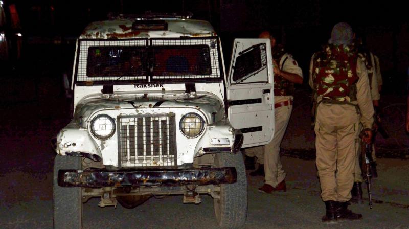 Security person stand guard after militants opened fire on the Amarnath Yatra in which some pilgrims were killed in Anantnag in Jammu and Kashmir on Monday. (Photo: PTI) Security person stand guard after militants opened fire on the Amarnath Yatra in which some pilgrims were killed in Anantnag in Jammu and Kashmir on Monday. (Photo: PTI)