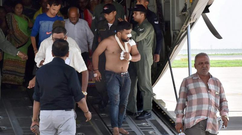 Amarnath pilgrims who were injured in Monday's terror attack at Anantnag in J & K, being brought by an IAF plane, at the airport in Surat on Tuesday. (Photo: PTI) Amarnath pilgrims who were injured in Monday's terror attack at Anantnag in J & K, being brought by an IAF plane, at the airport in Surat on Tuesday. (Photo: PTI)