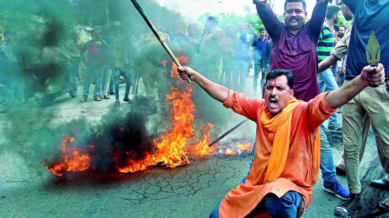 Activists of Bajrang Dal burning the tyres and blocking a road following a bandh call in response against the attack on pilgrims, in Jammu on Tuesday. Activists of Bajrang Dal burning the tyres and blocking a road following a bandh call in response against the attack on pilgrims, in Jammu on Tuesday.